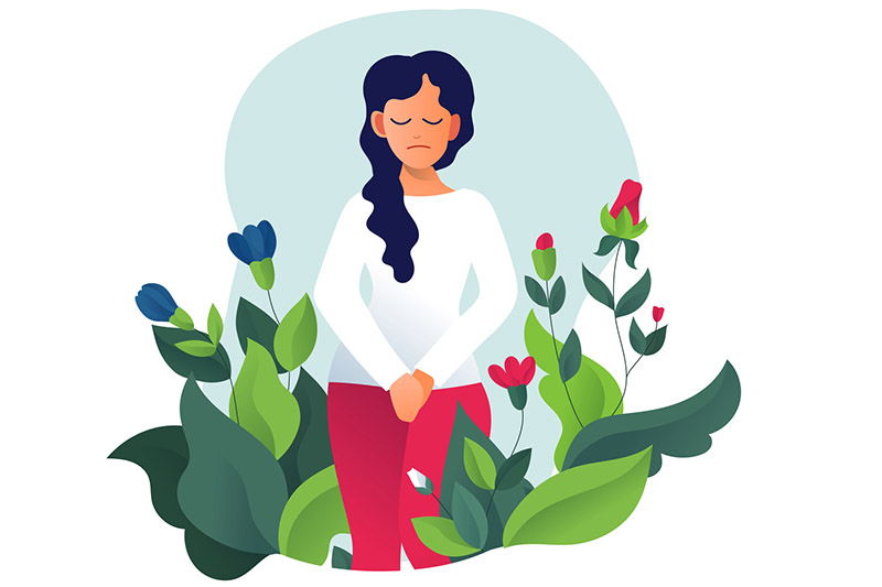 Ilustração de mulher de cabelos escuros e longos com as mãos em frente à região íntima, para artigo sobre o que é cervicite. Ela veste camiseta de manga longa branca e calça vermelha. Há plantas ao seu redor